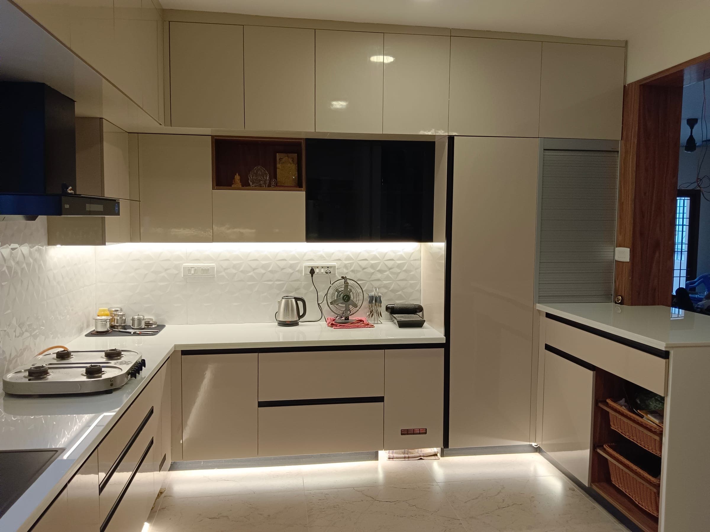 Detail of a champagne-lacquer modular kitchen with a hidden pooja niche, Anna Nagar West